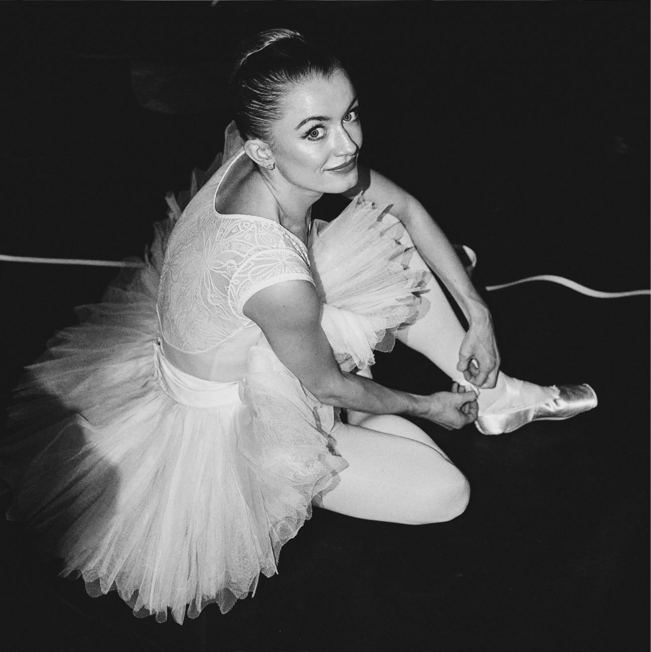 Anna Rose O'Sullivan tying ballet shoes